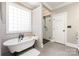 Bathroom with clawfoot tub, glass shower, subway tile and soft lighting for a relaxing spa-like feel at 254 Charter Se Ct, Concord, NC 28025