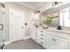 Modern bathroom showcasing a double vanity with white cabinets, sleek fixtures, and subway tile accents at 254 Charter Se Ct, Concord, NC 28025