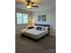 Bedroom featuring a ceiling fan, carpet flooring, and natural light from the window at 254 Charter Se Ct, Concord, NC 28025
