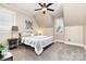 Cozy bedroom featuring a ceiling fan, neutral colors, carpet flooring, and natural light from the windows at 254 Charter Se Ct, Concord, NC 28025