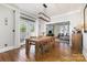 Bright dining room with hardwood floors, a modern light fixture, and access to an outdoor deck at 254 Charter Se Ct, Concord, NC 28025