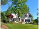Charming two-story home with a well-manicured lawn and mature trees at 254 Charter Se Ct, Concord, NC 28025