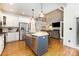 Modern kitchen with stainless steel appliances and a granite-topped island with pendant lighting at 254 Charter Se Ct, Concord, NC 28025