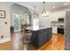 Modern kitchen featuring a large island, stainless steel appliances, and an adjacent breakfast nook at 254 Charter Se Ct, Concord, NC 28025