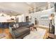 Open-concept living area with a large sectional sofa, hardwood floors, and a staircase at 254 Charter Se Ct, Concord, NC 28025