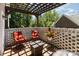 Relaxing patio area with a pergola, brick privacy walls, and comfortable seating arrangement at 254 Charter Se Ct, Concord, NC 28025