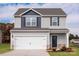 Charming two-story home with gray siding, a two-car garage, and a well-maintained lawn at 3315 Burberry Dr, Gastonia, NC 28052