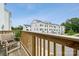 Balcony view of white townhomes under a blue sky from a wooden balcony with a chair at 4148 Alexander View Dr, Charlotte, NC 28226