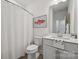 Cozy bathroom with a white vanity, modern fixtures, and a shower with a white curtain at 4148 Alexander View Dr, Charlotte, NC 28226