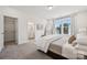 Serene bedroom featuring plush carpeting, a large window, and a glimpse into an en-suite bathroom at 4148 Alexander View Dr, Charlotte, NC 28226
