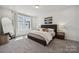 Bright bedroom with neutral decor, large window, carpet flooring, and stylish furnishings for a serene retreat at 4148 Alexander View Dr, Charlotte, NC 28226