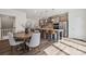 Dining area with a round wooden table, comfortable seating, and an open view to the modern kitchen at 4148 Alexander View Dr, Charlotte, NC 28226