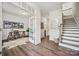 Inviting entryway with hardwood floors, white walls, staircase, and office space through glass French doors at 4148 Alexander View Dr, Charlotte, NC 28226