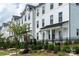 Row of townhomes featuring white exteriors, black windows, and well-maintained landscaping at 4148 Alexander View Dr, Charlotte, NC 28226