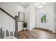 Bright foyer with hardwood floors, white walls, gray trim, decorative art and a view of the front door at 4148 Alexander View Dr, Charlotte, NC 28226