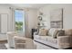 Bright living room with a plush sofa, decorative shelving, neutral tones and large picture window at 4148 Alexander View Dr, Charlotte, NC 28226