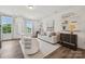Elegant living room with stylish decor, large windows, light-colored walls and lots of comfortable seating at 4148 Alexander View Dr, Charlotte, NC 28226