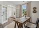 Sunlit office with a rustic wood desk, chair, light walls, decorative globe, and a large window at 4148 Alexander View Dr, Charlotte, NC 28226