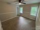 This bedroom features neutral walls, a ceiling fan, and two windows at 4221 Hounds Run Dr, Matthews, NC 28105