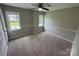 This bedroom features neutral walls, a ceiling fan, and two windows at 4221 Hounds Run Dr, Matthews, NC 28105