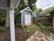 The yard includes a small storage building with white doors and dark green siding at 4221 Hounds Run Dr, Matthews, NC 28105