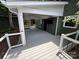 This large gray deck has railings, a covered porch, and a mounted television at 4221 Hounds Run Dr, Matthews, NC 28105