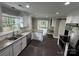 Bright kitchen with white cabinets, stainless steel appliances, and an open layout leading to the dining area at 4221 Hounds Run Dr, Matthews, NC 28105