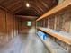 Spacious shed interior with shelving and a small window for natural light, ideal for storage or a workshop at 4221 Hounds Run Dr, Matthews, NC 28105