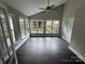 Light-filled sun room with large windows, hardwood floors, and a ceiling fan; perfect for relaxation at 4221 Hounds Run Dr, Matthews, NC 28105