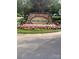 Stone community sign for Water's Edge surrounded by colorful flowers and greenery at 448 River Park Rd, Belmont, NC 28012