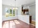 Elegant dining area with a chandelier, wainscoting, and natural light at 448 River Park Rd, Belmont, NC 28012