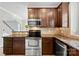Well-equipped kitchen with dark wood cabinets, stainless steel appliances, and granite countertops at 448 River Park Rd, Belmont, NC 28012