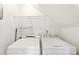 Convenient laundry area with a washer, dryer, and shelving for storage at 448 River Park Rd, Belmont, NC 28012