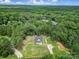Aerial view showcasing the home nestled within a lush, green forest at 4592 Reid Rd, Edgemoor, SC 29712