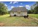 Backyard featuring green grass, grill and chairs at 4592 Reid Rd, Edgemoor, SC 29712