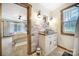 Bathroom with a view to the bedroom, featuring modern vanity, sink, and wood-look tile at 4592 Reid Rd, Edgemoor, SC 29712