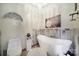 Bathroom featuring a modern white standalone tub, toilet, decorative lighting and artwork at 4592 Reid Rd, Edgemoor, SC 29712