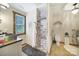 Bathroom with a wood-framed window, gray shower, modern sink and toilet, wood flooring at 4592 Reid Rd, Edgemoor, SC 29712