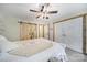 Comfortable bedroom featuring wood sliding door, neutral colors, wood floors, and ceiling fan at 4592 Reid Rd, Edgemoor, SC 29712
