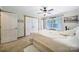 Bright bedroom featuring two white closets, neutral colors, wood floors, and ceiling fan at 4592 Reid Rd, Edgemoor, SC 29712