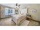 Bright bedroom with a white bed frame, ceiling fan, and natural light from the window at 4592 Reid Rd, Edgemoor, SC 29712