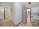 Hallway featuring a water heater and stacked washer/dryer, with wood trim and neutral walls at 4592 Reid Rd, Edgemoor, SC 29712