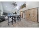 Open-concept living room with high ceilings, wood floors, and a rustic-style kitchen island with barstool seating at 4592 Reid Rd, Edgemoor, SC 29712