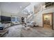 Open living area with wood floors, staircase, and large windows at 4592 Reid Rd, Edgemoor, SC 29712