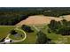 Expansive property featuring two homes, a large field, and bordered by lush greenery and mature trees at 4713 White Store Rd, Wingate, NC 28174