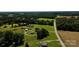 Expansive aerial view showcasing houses and fields, combining comfort with a rural lifestyle at 4713 White Store Rd, Wingate, NC 28174