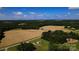 Aerial shot highlighting homes and golden fields, offering a blend of comfort and nature at 4713 White Store Rd, Wingate, NC 28174