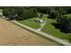 Aerial view of the home set amidst fields and trees, blending rural living with accessibility at 4713 White Store Rd, Wingate, NC 28174