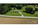 Aerial view of a charming home nestled on a sprawling green lot with mature trees at 4713 White Store Rd, Wingate, NC 28174