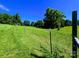 Idyllic green field with fence posts under a bright sky, great for outdoor activities at 4713 White Store Rd, Wingate, NC 28174